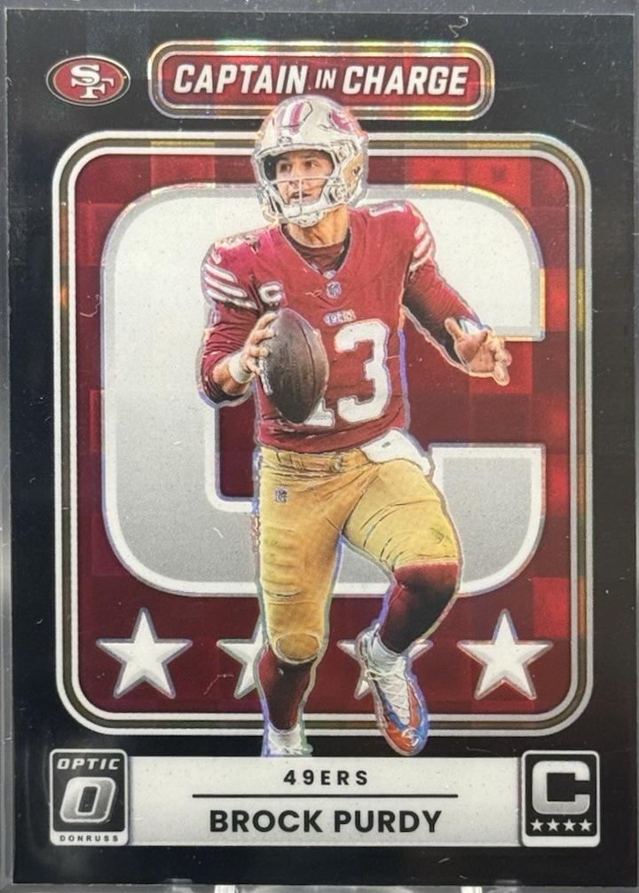 2025 Panini Donruss Optic Captain in Charge Brock Purdy [Black Pandora] #1 card
